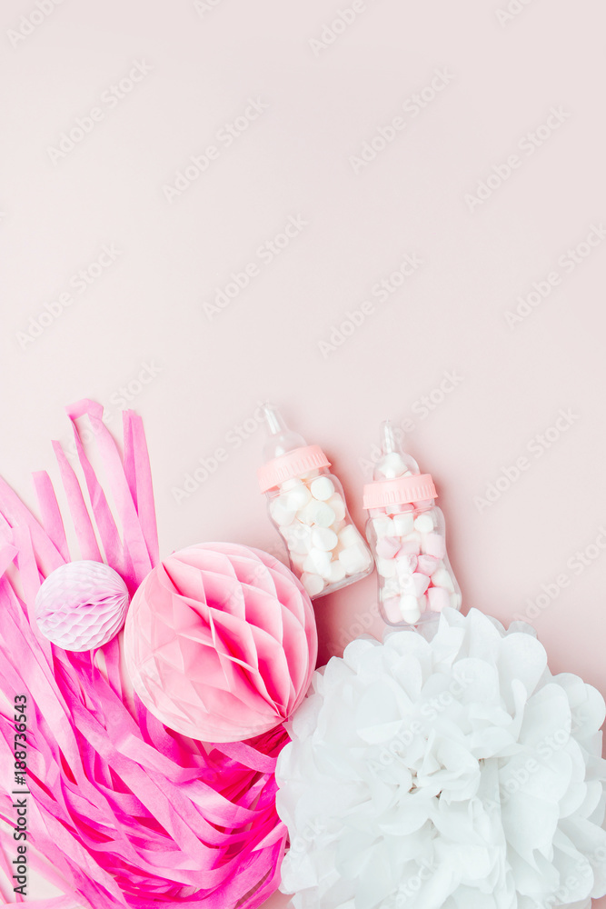 Decorative Baby milk bottles with candy and paper decorations for Baby shower party. Flat lay, top view Decorative Baby milk bottles with candy and paper decorations for Baby shower party. Flat lay, top view