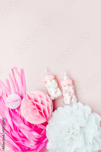 Decorative Baby milk bottles with candy and paper decorations for Baby shower party. Flat lay, top view