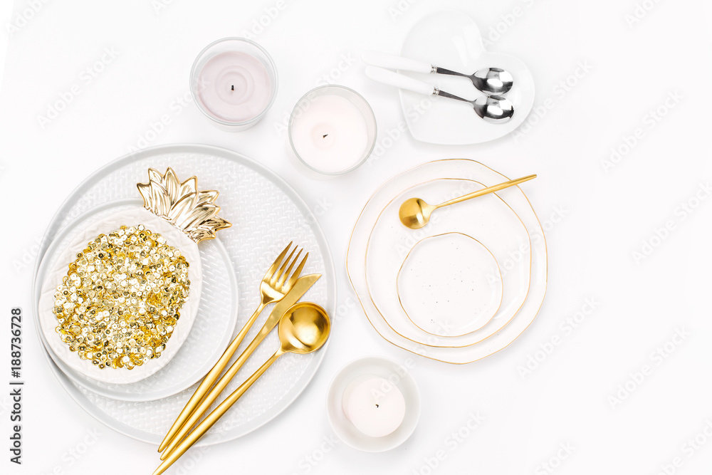 Tableware and decorations for serving a festive table. Plates, wine glasses and cutlery with candles on white background. Tableware and decorations for serving a festive table. Plates, wine glasses and cutlery with candles on white background.