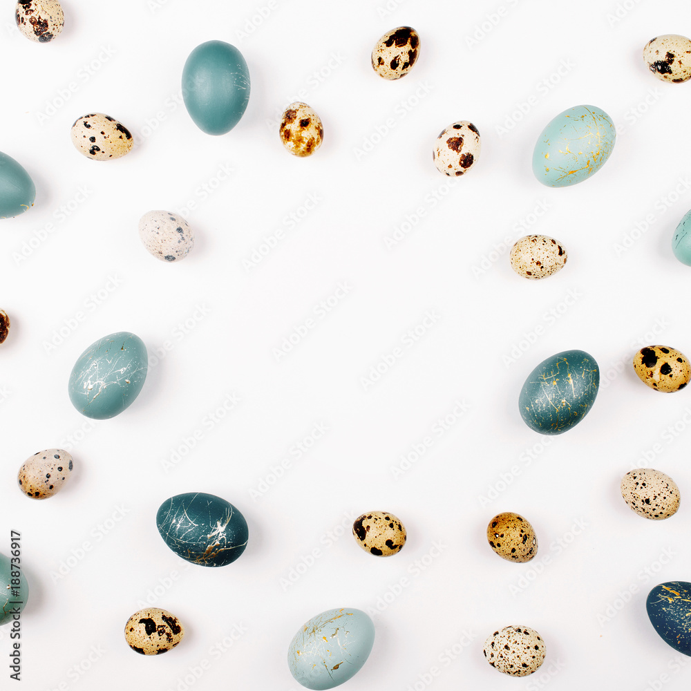 Stylish Frame background with quail and blue easter eggs with copy space for text. isolated on white background. Flat lay, top view. Easter concept.