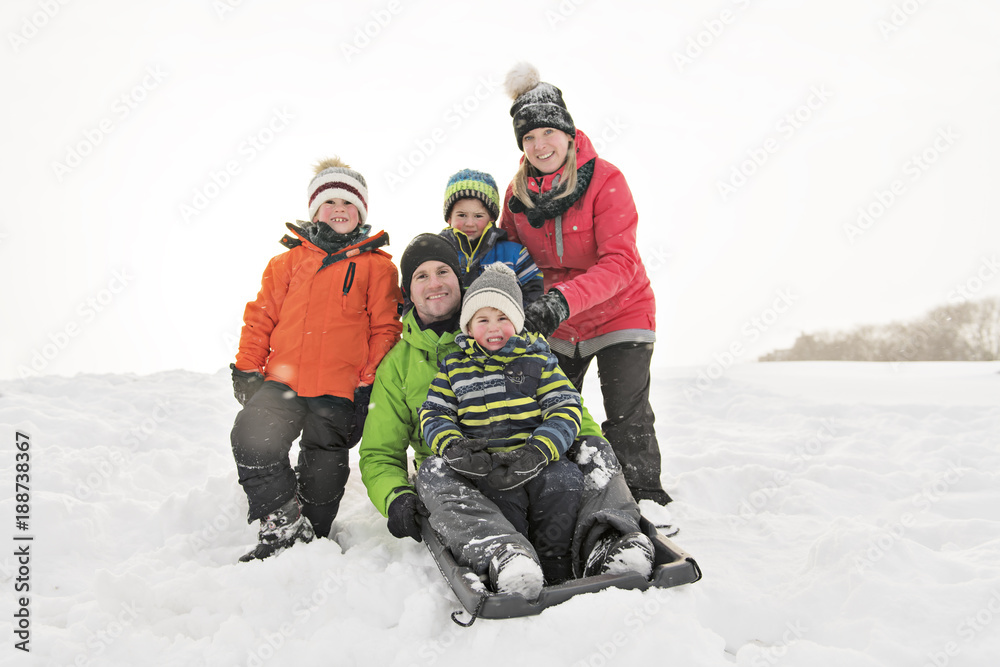 family and child spending time outdoor in winter