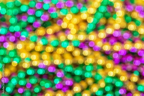 Fototapeta Out of focus background of shiny and colorful Mardi Gras beads