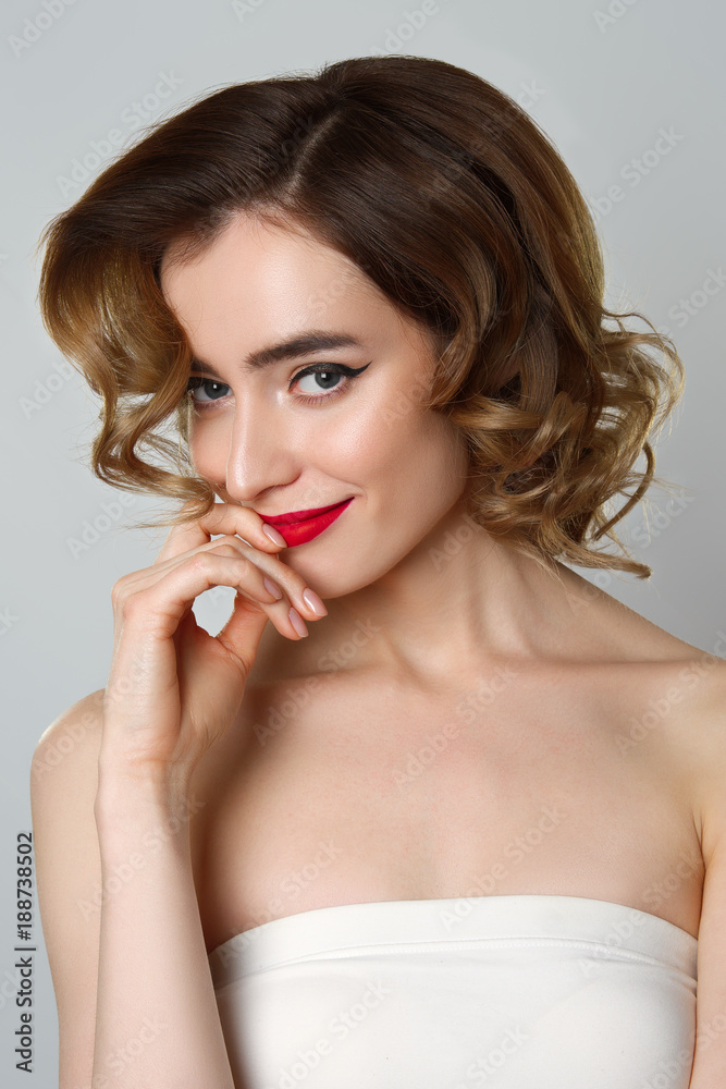 Beauty portrait of pretty girl with curly hair, cat eye make-up, red lips. Beauty, cosmetics concept. Healthcare. Beauty portrait of pretty girl with curly hair, cat eye make-up, red lips. Beauty, cosmetics concept. Healthcare.