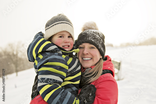 Mother and Son In Snowy Landscape