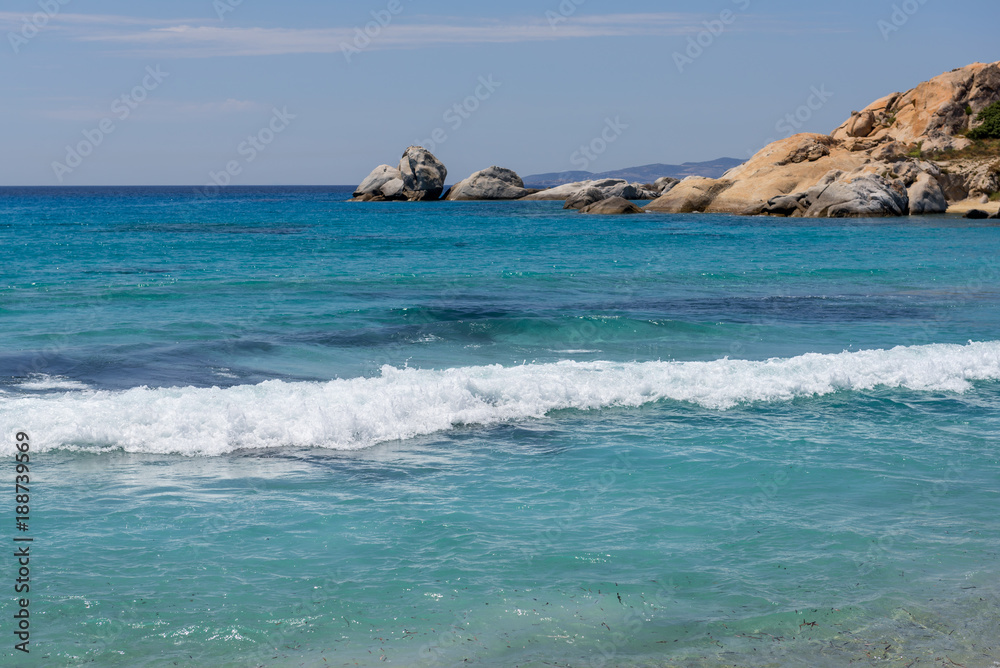 Sea with with shallow crystal clear sea water, Mikri Vigla beach on Naxos island, Greece