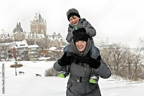 Mother and Son on his shoulder In Snowy Landscape