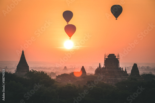 Hot air baloons above temples at sunrise