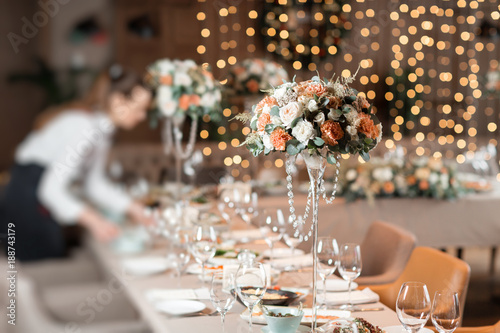 Decorated table in the restaurant, the preparation before the banquet. the work of professional florists.