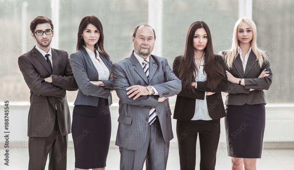 portrait of successful businessman and business team standing together with arms crossed in front of him portrait of successful businessman and business team standing together with arms crossed in front of him