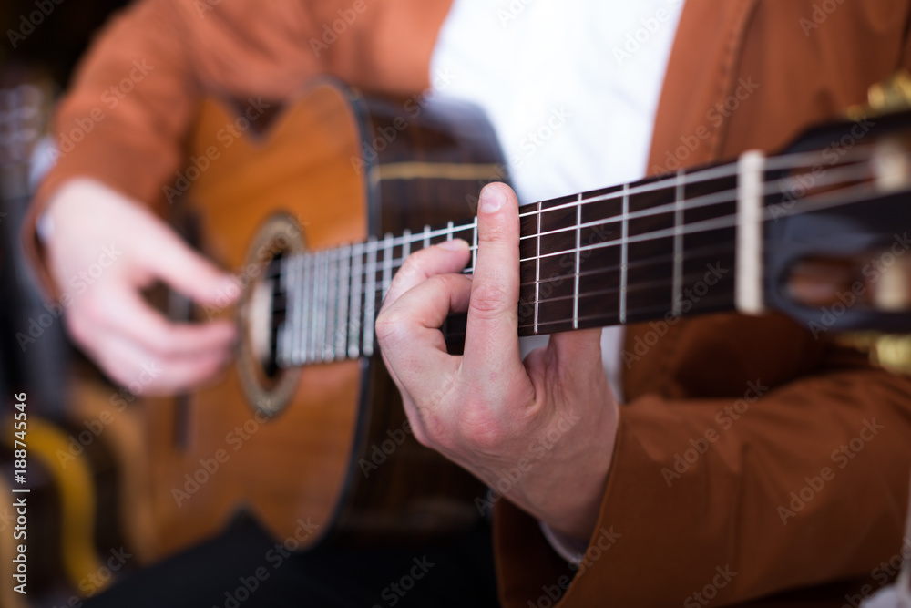 Professional guitarist practicing on guitar
