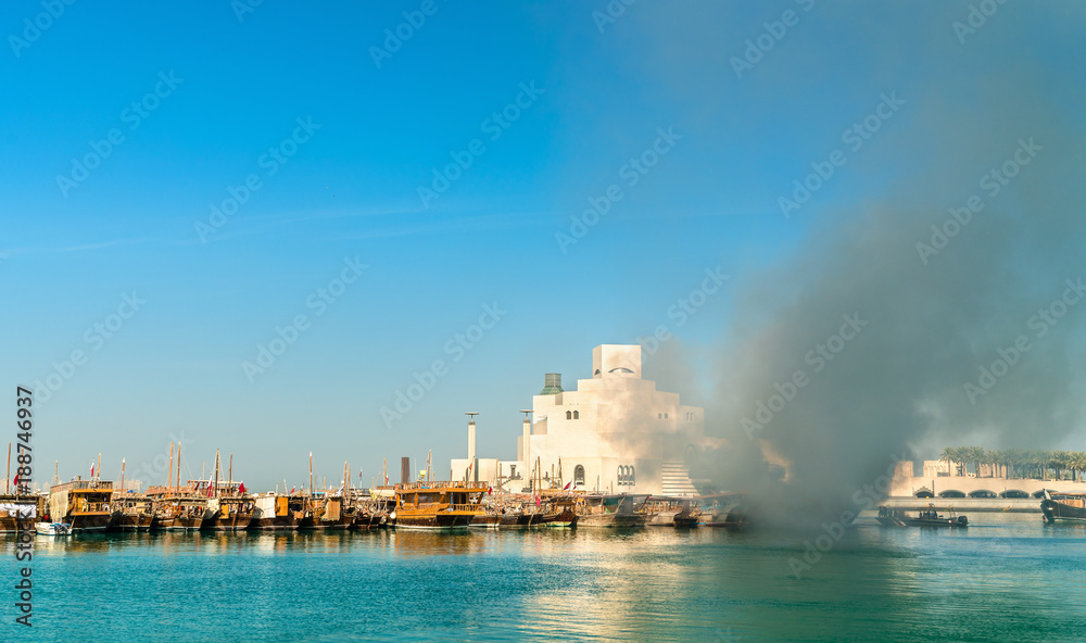 Traditional arabic dhow on fire in Doha, Qatar