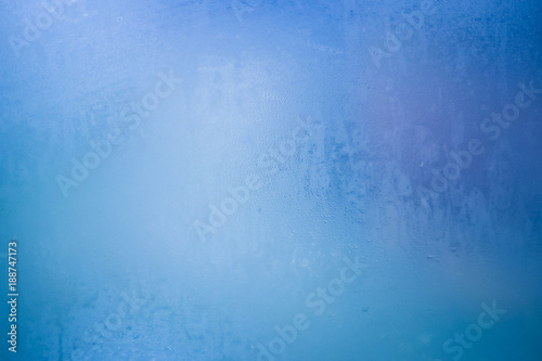 Condensed water on the window glass. Blue texture background of water on window