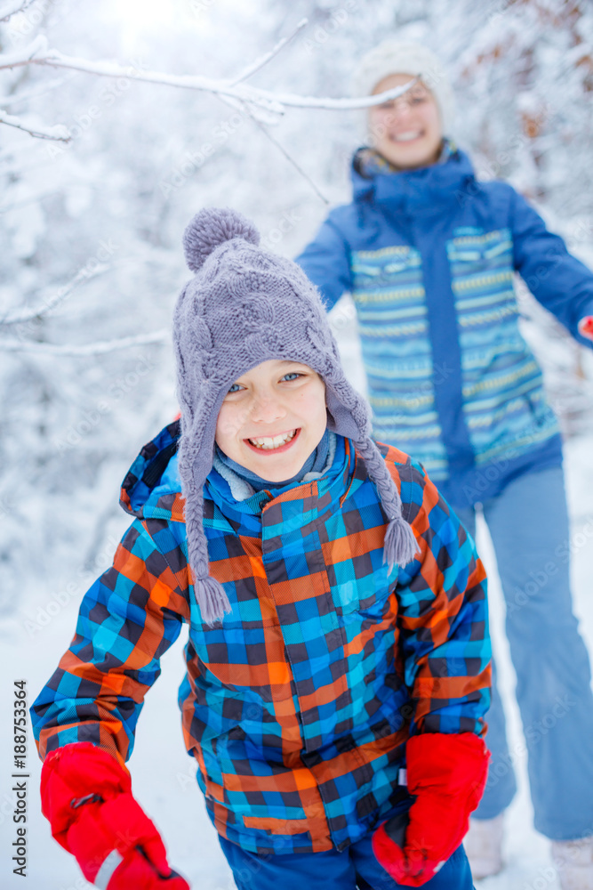 Happy children playing on snowy winter day.
