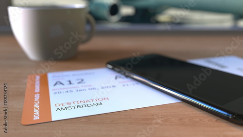 Photography Boarding pass to Amsterdam and smartphone on the table in airport while travelling to Netherlands