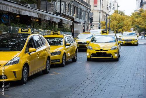 Taxi station, yellow taxi vehicles on the street of the big city