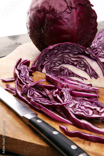 Shredded cabbage, red cabbage on wooden cutting board