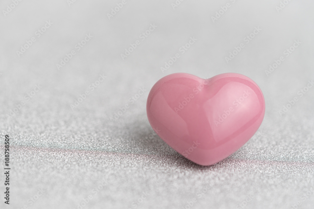 Valentines card or background with cute pink heart shape on glitter reflective particle white paper Valentines card or background with cute pink heart shape on glitter reflective particle white paper