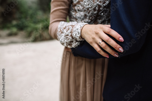 Groom and brides hands with rings, closeup view