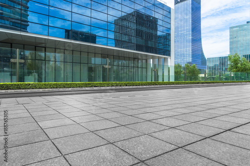 modern glass building exterior with empty pavement