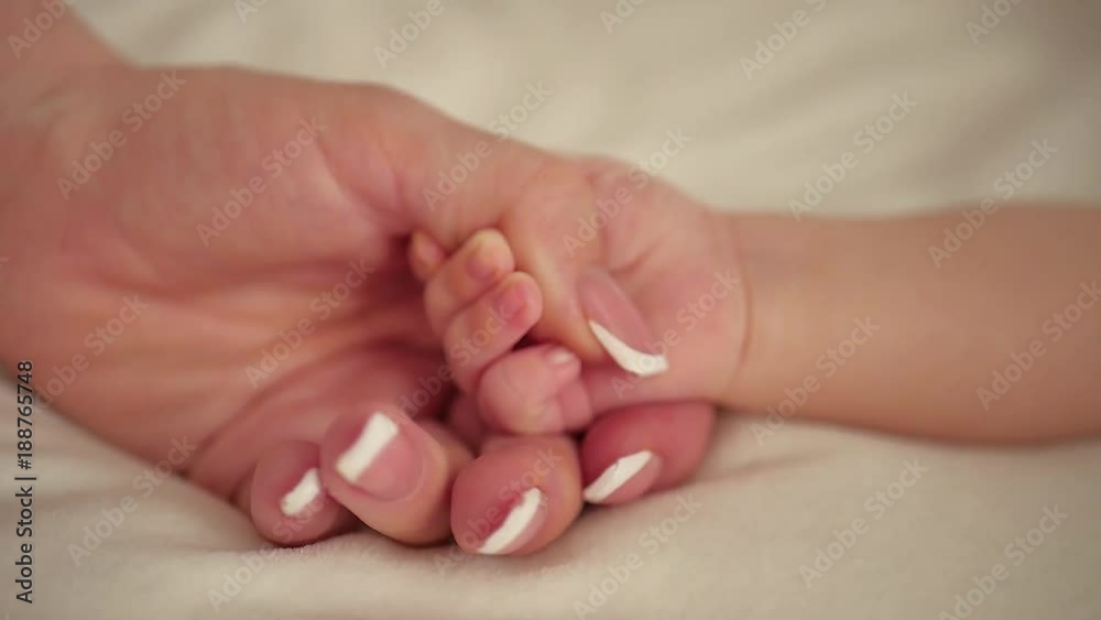 Mother and her newborn baby, parent holding newborns hand, happy mother and baby together. Maternity and parenthood concept. Mother and her newborn baby, parent holding newborns hand, happy mother and baby together. Maternity and parenthood concept.