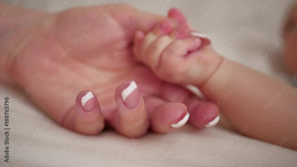 Mother and her newborn baby, parent holding newborns hand, happy mother and baby together. Maternity and parenthood concept. Mother and her newborn baby, parent holding newborns hand, happy mother and baby together. Maternity and parenthood concept.