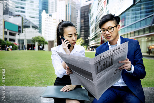 Photography Asian business people reading the newspaper