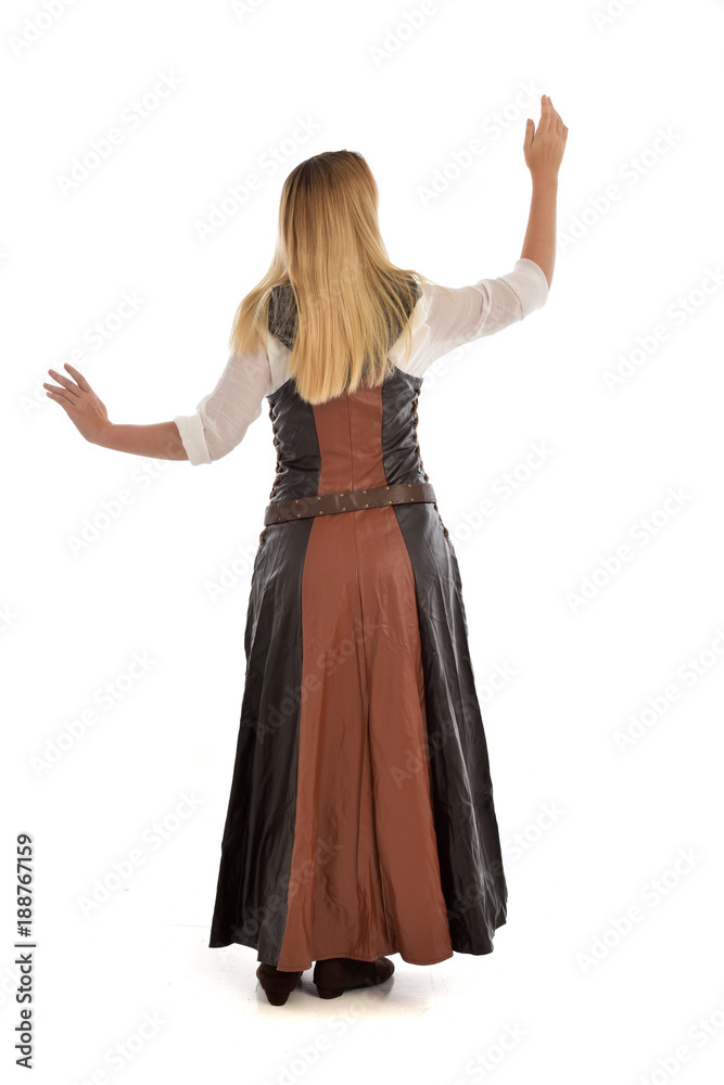 full length portrait of girl wearing brown fantasy costume.. standing pose with back to the camera on white studio background. full length portrait of girl wearing brown fantasy costume.. standing pose with back to the camera on white studio background.