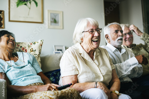 Senior people watching televison together photo