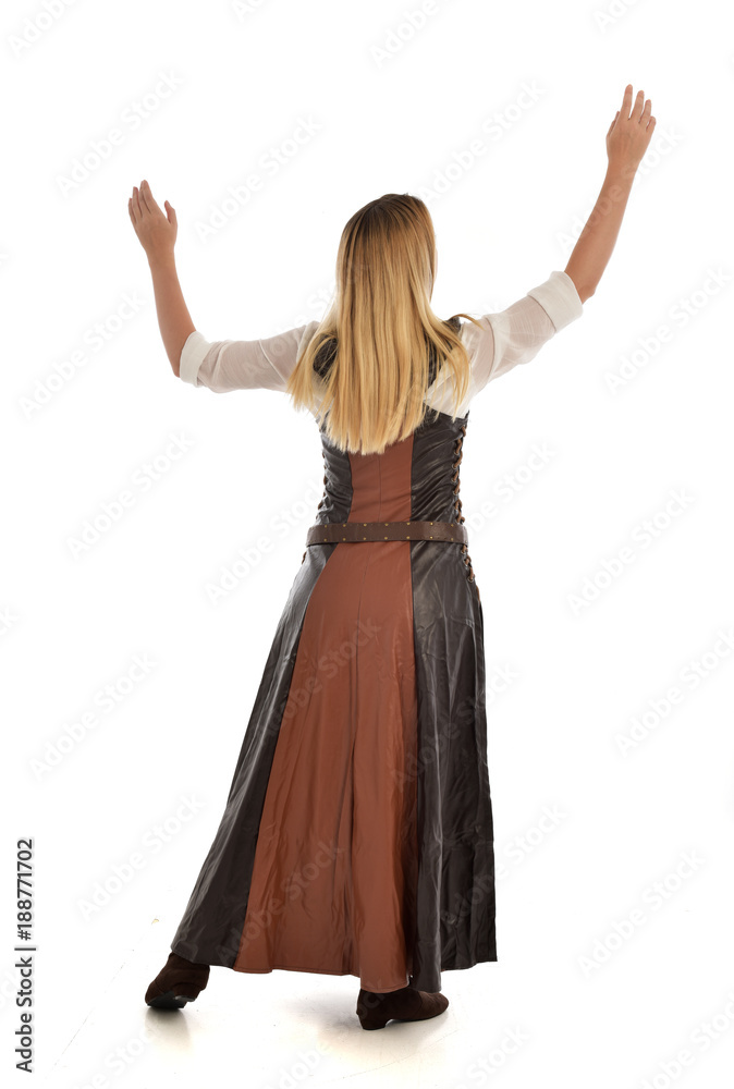 full length portrait of girl wearing brown fantasy costume, standing pose with back to the camera on white studio background. full length portrait of girl wearing brown fantasy costume, standing pose with back to the camera on white studio background.