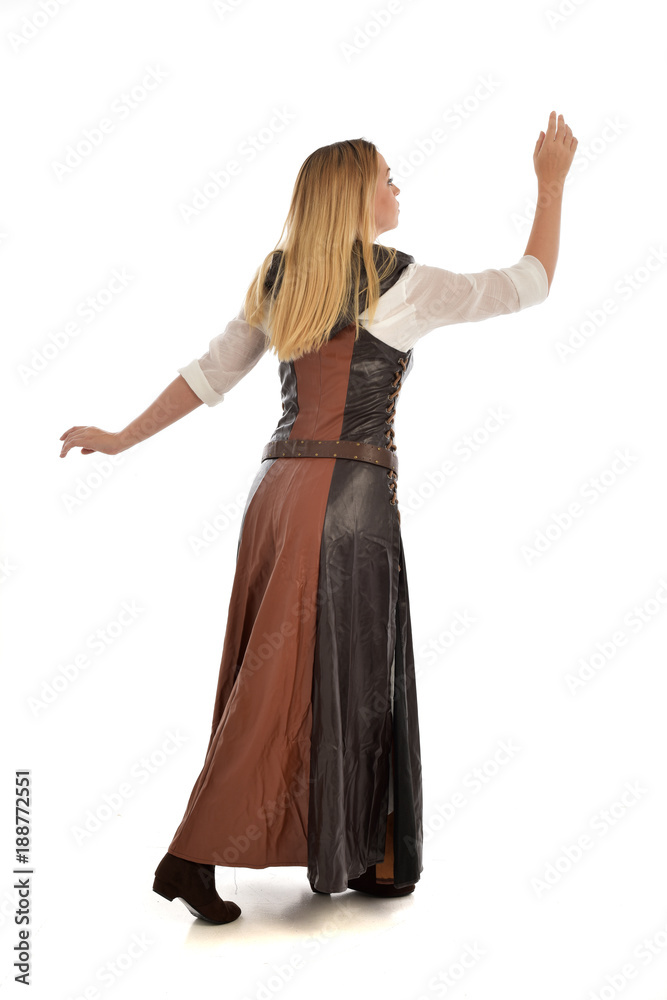 full length portrait of girl wearing brown fantasy costume, standing pose with back to the camera on white studio background. full length portrait of girl wearing brown fantasy costume, standing pose with back to the camera on white studio background.