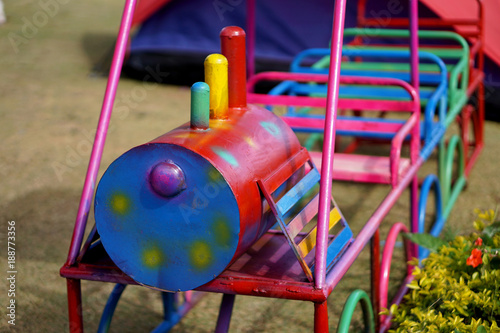 Iron train swinging at the playground under the sunlight in summer