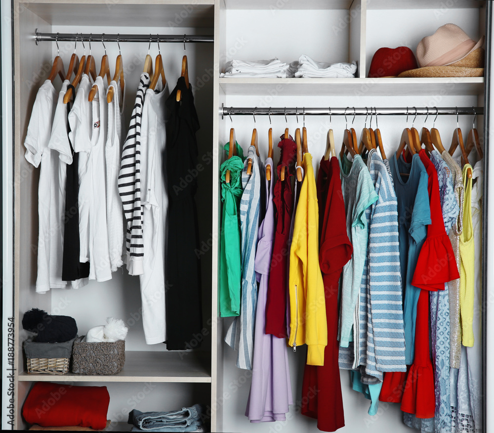 Wardrobe with many different clothes, closeup