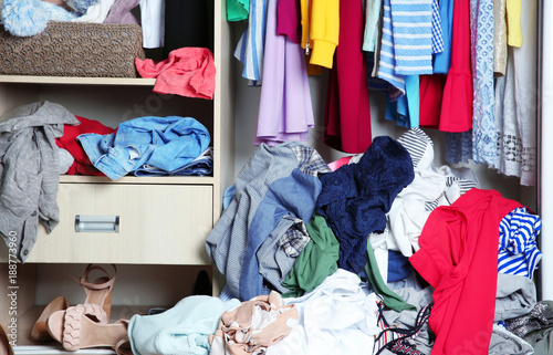 Wardrobe with messy clothes, closeup photo