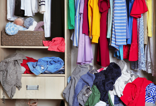 Wardrobe with messy clothes, closeup photo