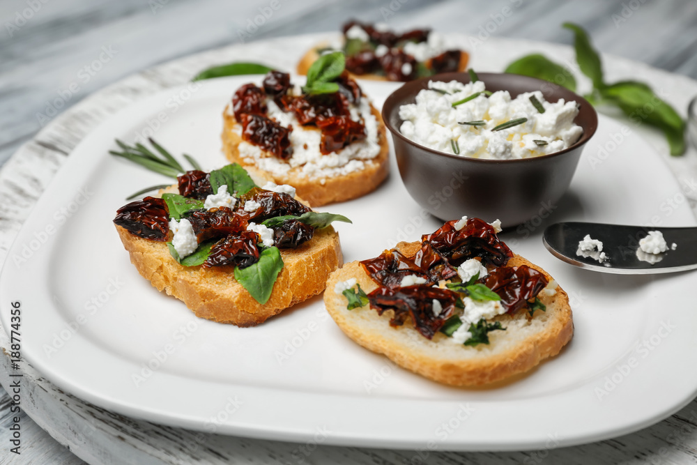 Tasty bruschettas with sun-dried tomatoes on plate, closeup Tasty bruschettas with sun-dried tomatoes on plate, closeup