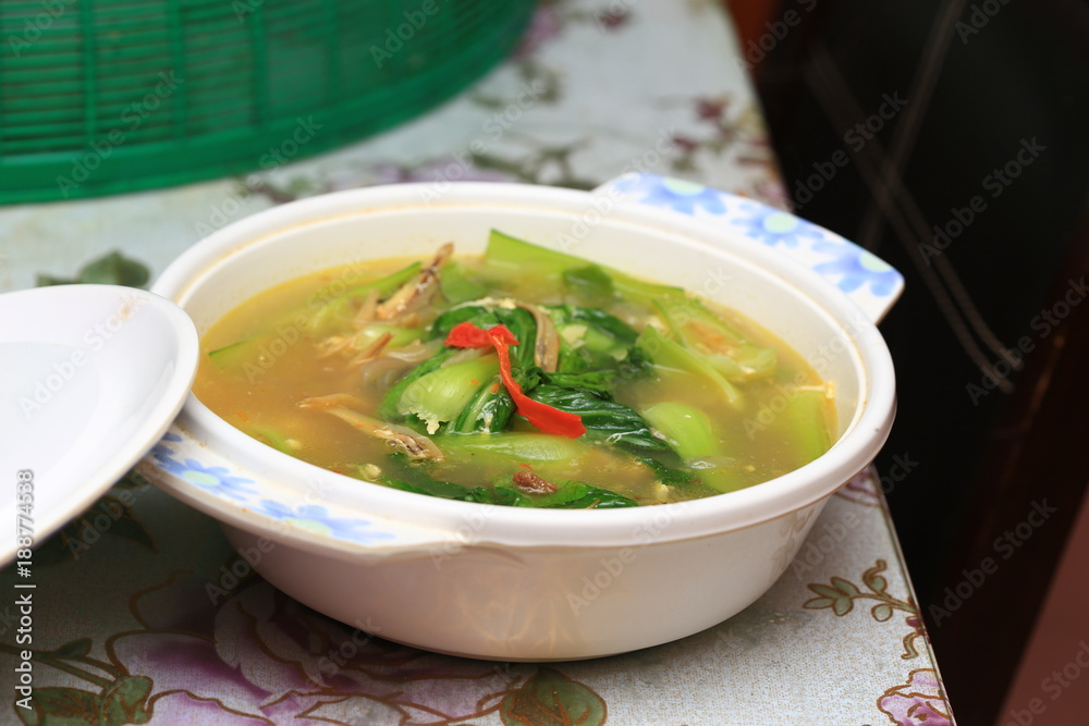 Chinese or Asian cuisine : Soup of baby bok choy or pok choi, green Chinese cabbage on table. Health lifestyle, diet concept. Selective focus Chinese or Asian cuisine : Soup of baby bok choy or pok choi, green Chinese cabbage on table. Health lifestyle, diet concept. Selective focus