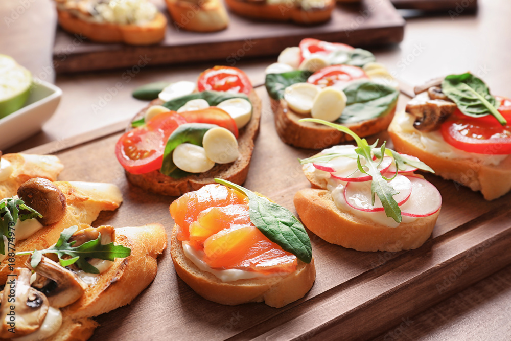 Tasty bruschettas on wooden board, closeup Tasty bruschettas on wooden board, closeup