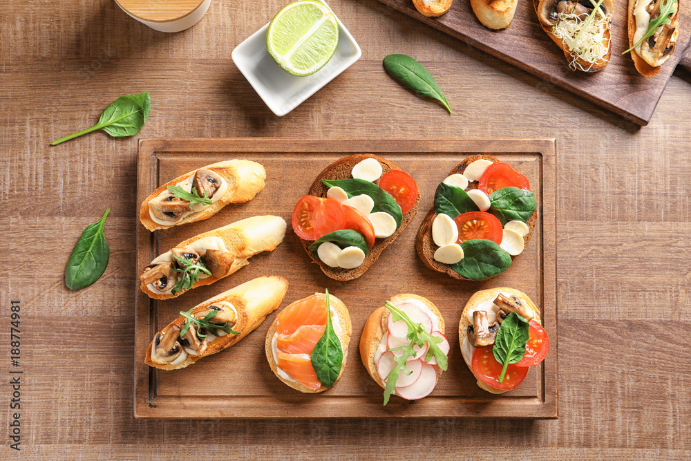Tasty bruschettas on wooden board, top view Tasty bruschettas on wooden board, top view