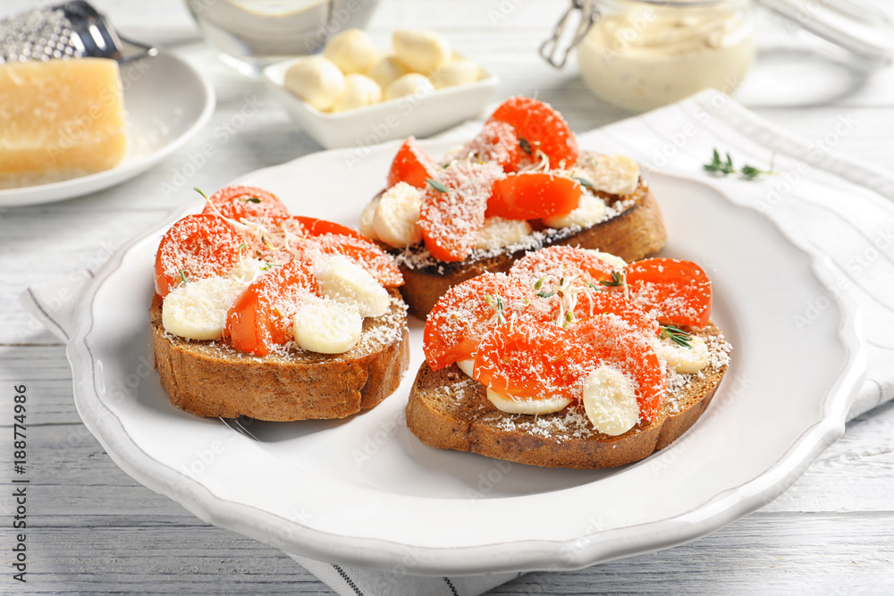 Tasty bruschettas with cherry tomatoes and cheese on plate, closeup Tasty bruschettas with cherry tomatoes and cheese on plate, closeup