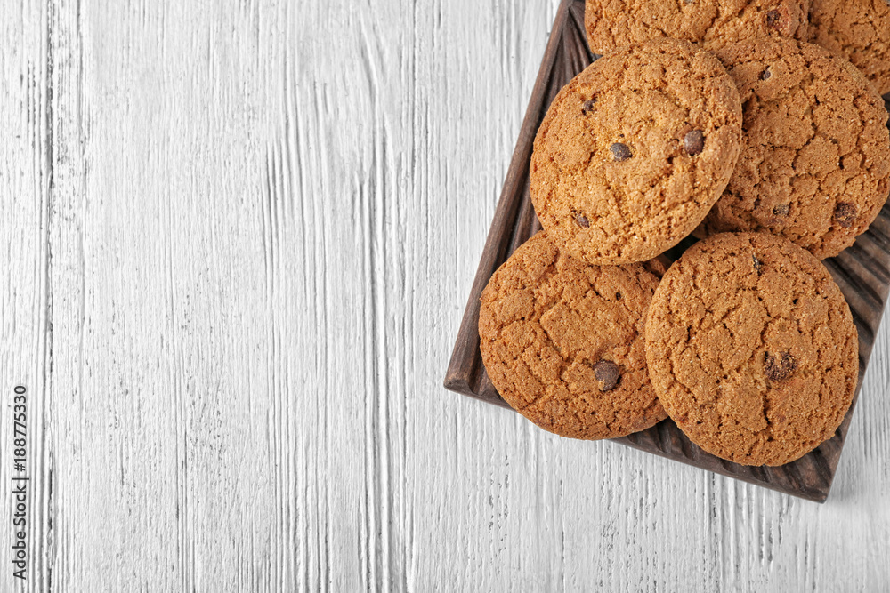 Delicious oatmeal cookies with chocolate chips on wooden board Delicious oatmeal cookies with chocolate chips on wooden board
