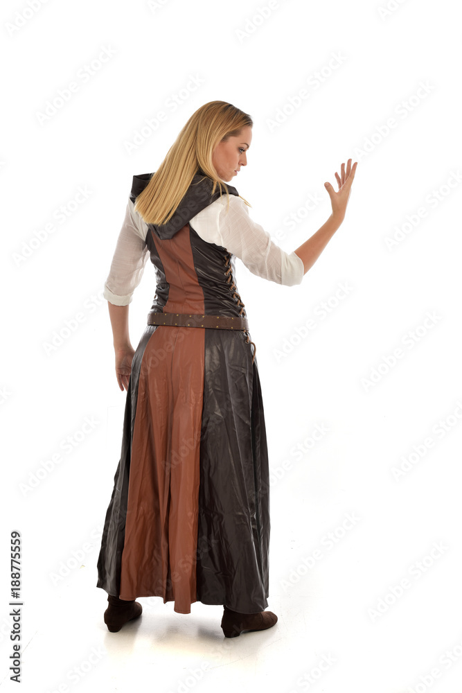 full length portrait of girl wearing brown  fantasy costume, standing pose with back to the camera on white studio background. 