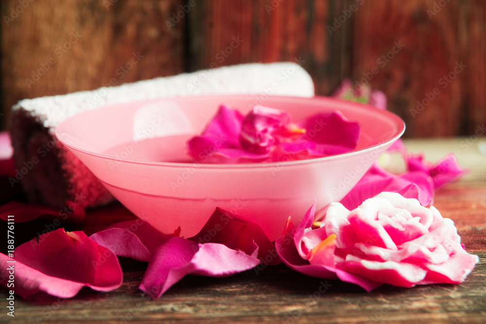 Spa setting with rose pink flowers and petals,bath salt and body-oil Spa setting with rose pink flowers and petals,bath salt and body-oil