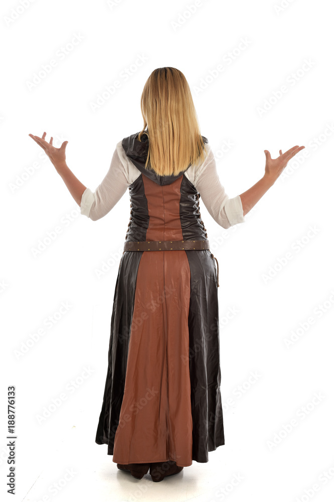 full length portrait of girl wearing brown fantasy costume, standing pose with back to the camera on white studio background. full length portrait of girl wearing brown fantasy costume, standing pose with back to the camera on white studio background.