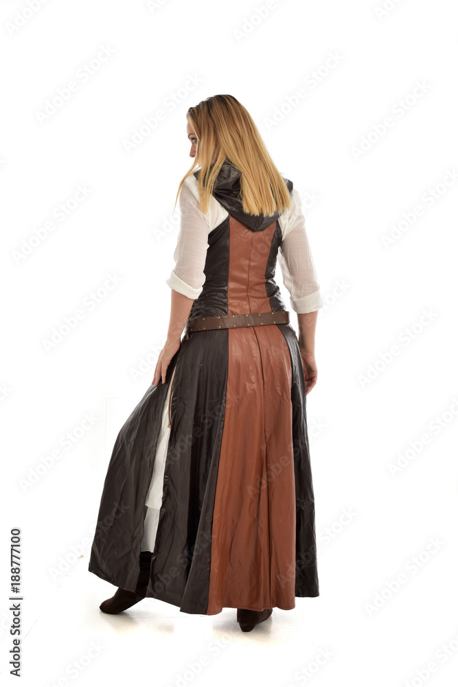 full length portrait of girl wearing brown fantasy costume, standing pose with back to the camera on white studio background. full length portrait of girl wearing brown fantasy costume, standing pose with back to the camera on white studio background.