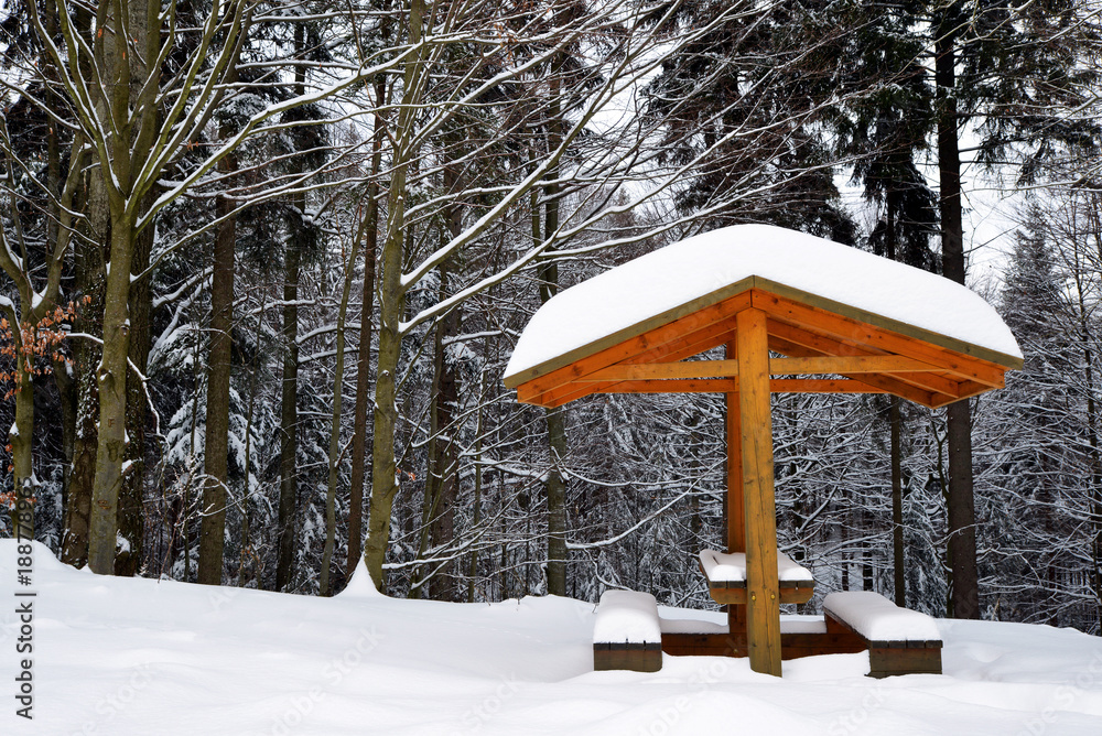 Snowy bench in winter landscape. National park Sumava in Czech Republic. Snowy bench in winter landscape. National park Sumava in Czech Republic.
