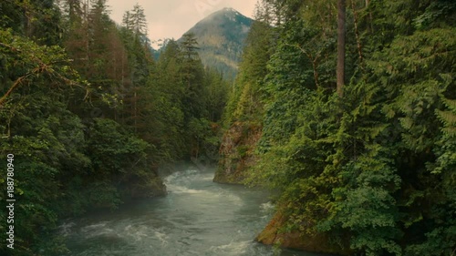 River flowing through landscape with mountain