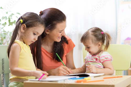 Teacher working with childr...