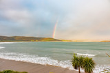 New Zealand Curio Bay dolphin bay sunset with a rainbow beach