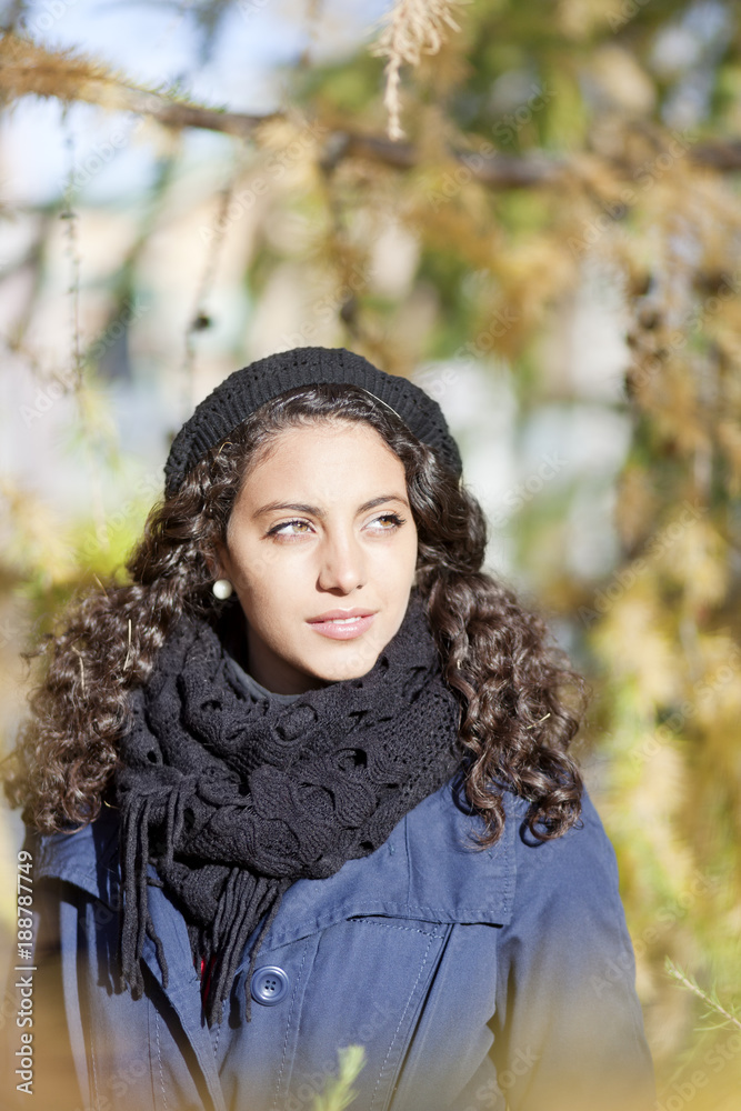 Portrait of young woman with curly hair on sunny day Portrait of young woman with curly hair on sunny day