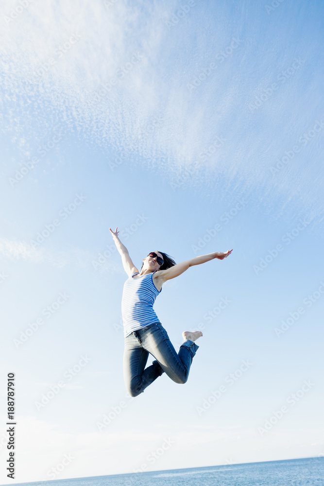 View of woman in sunglasses jumping View of woman in sunglasses jumping